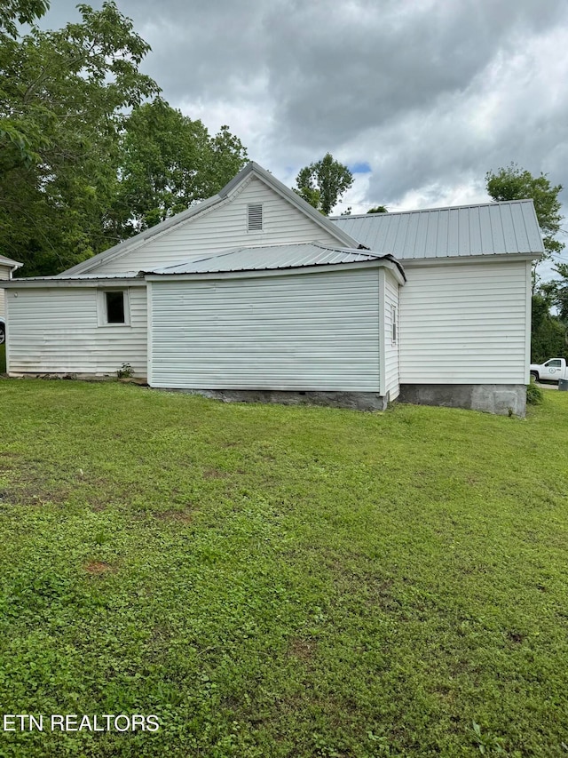 view of side of property with a yard