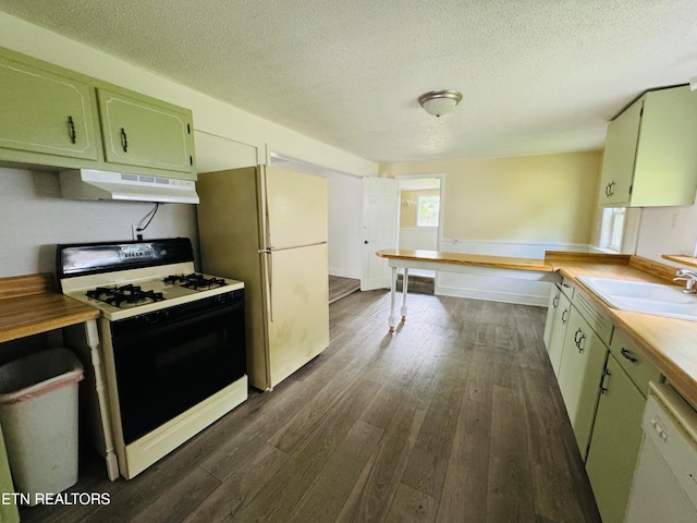 kitchen featuring butcher block counters, sink, white appliances, and dark hardwood / wood-style floors