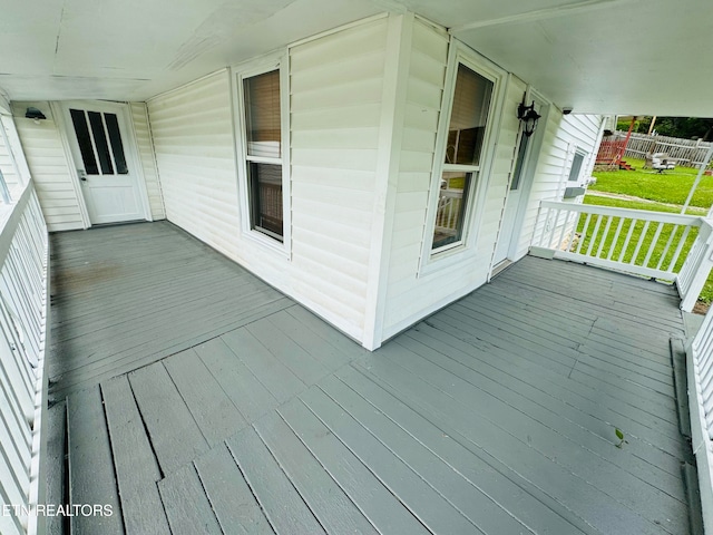 wooden deck featuring a yard