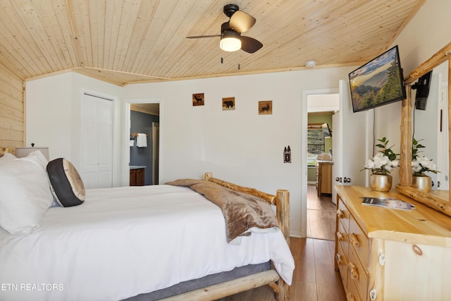 bedroom featuring dark wood-type flooring, a closet, ceiling fan, wooden ceiling, and ensuite bathroom