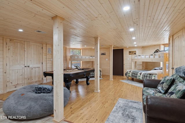 living room featuring wood ceiling, light hardwood / wood-style flooring, and wood walls