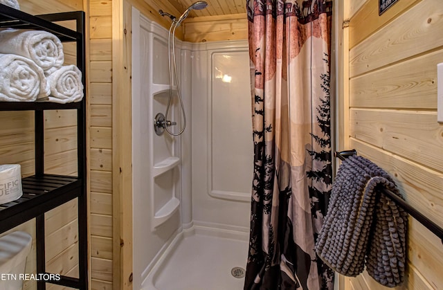 bathroom with walk in shower, wooden walls, and wooden ceiling