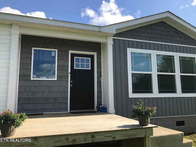 view of exterior entry featuring a deck