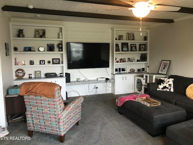 carpeted living room with beamed ceiling, built in shelves, and ceiling fan