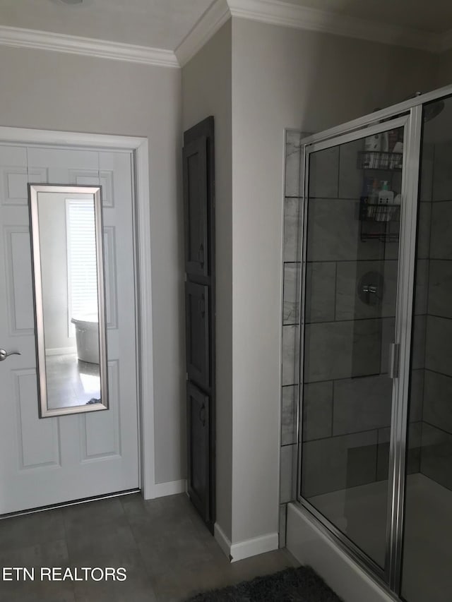 bathroom featuring tile flooring, ornamental molding, and an enclosed shower