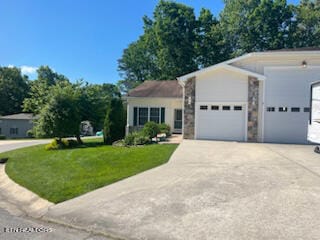 view of front facade with a garage and a front lawn