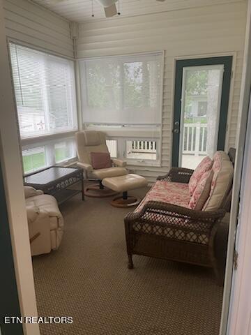 sunroom featuring an AC wall unit