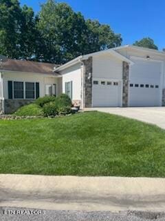 single story home featuring a front yard and a garage