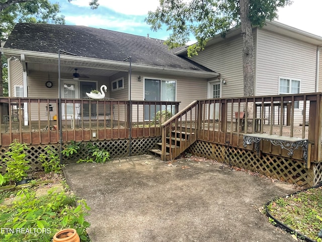 rear view of property with a deck and ceiling fan