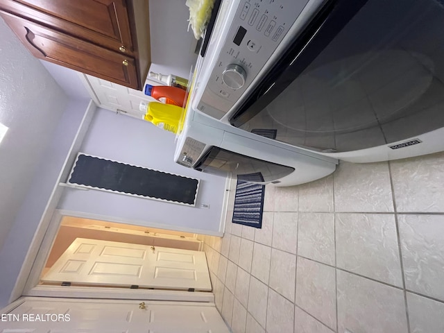 interior space featuring tile floors and tile walls