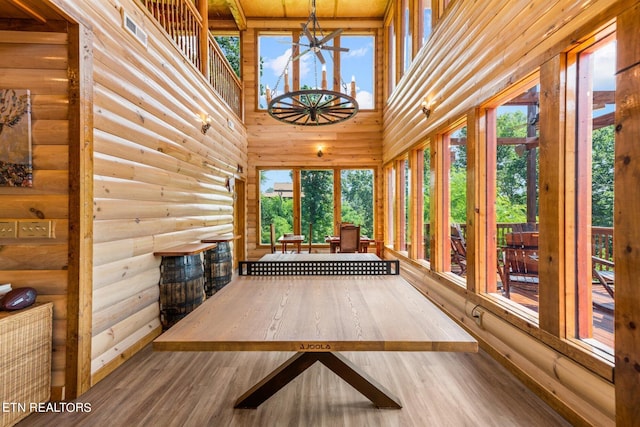 unfurnished sunroom with an inviting chandelier