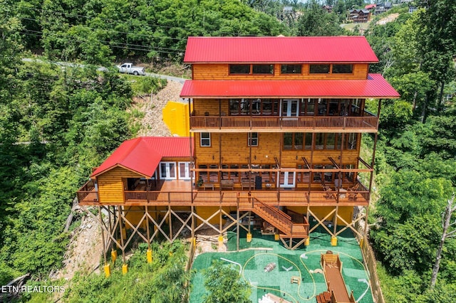 rear view of property with a wooden deck