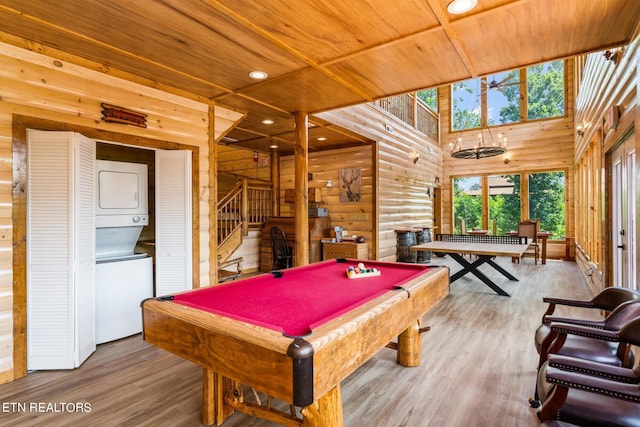 rec room featuring stacked washer and dryer, billiards, hardwood / wood-style floors, and wood ceiling