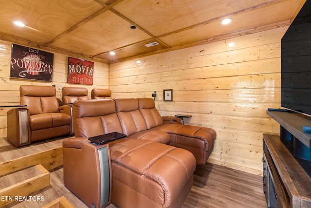 cinema room with wood walls and hardwood / wood-style flooring