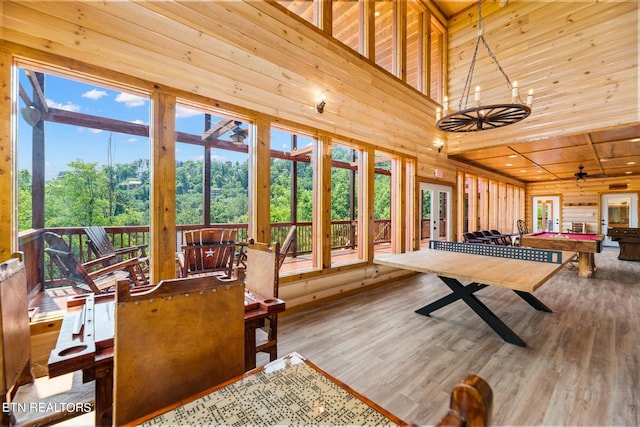 game room with billiards, a towering ceiling, hardwood / wood-style floors, and wood ceiling