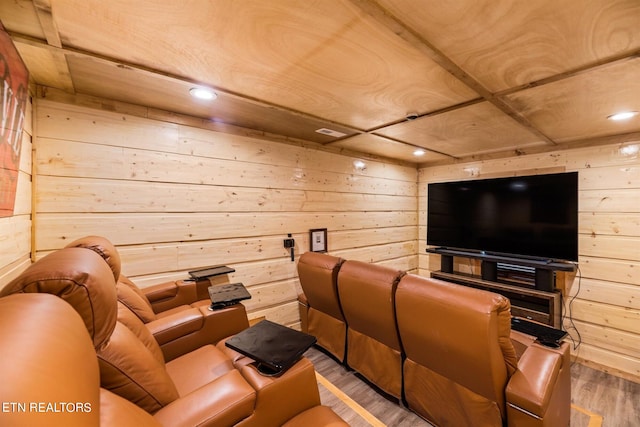 cinema room featuring wood-type flooring and wood walls