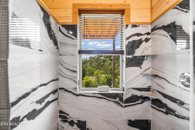 bathroom with tile walls