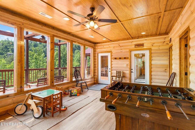 rec room with a wealth of natural light, wooden ceiling, rustic walls, and light hardwood / wood-style floors