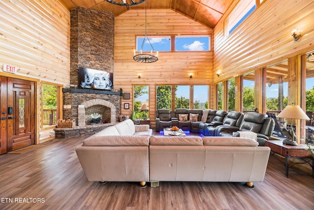 living room with high vaulted ceiling, wood ceiling, wood walls, and hardwood / wood-style floors