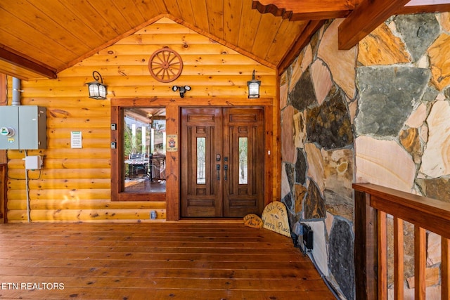 entryway featuring wood ceiling, lofted ceiling, rustic walls, and wood-type flooring