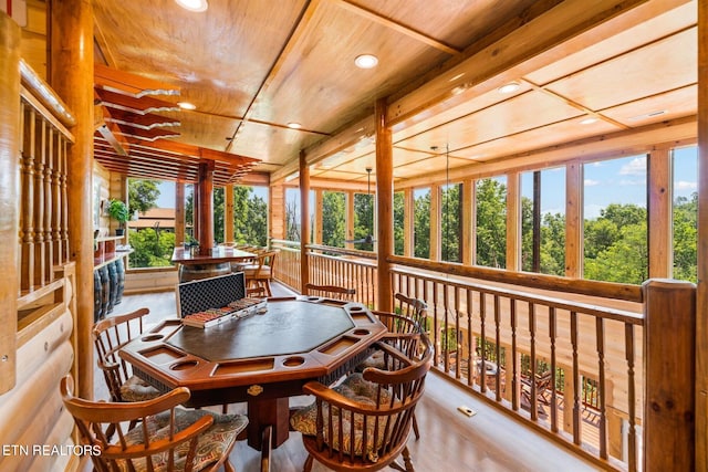 sunroom with plenty of natural light and wooden ceiling