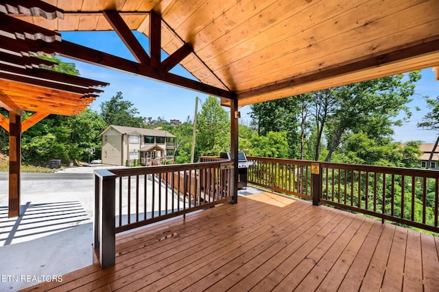 wooden deck featuring a grill