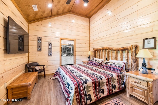 bedroom with ceiling fan, wood ceiling, wood-type flooring, wooden walls, and lofted ceiling