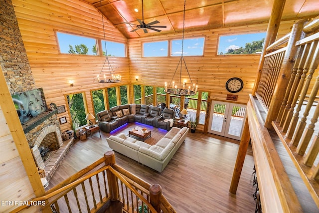 living room featuring a fireplace, ceiling fan with notable chandelier, hardwood / wood-style flooring, wooden ceiling, and high vaulted ceiling