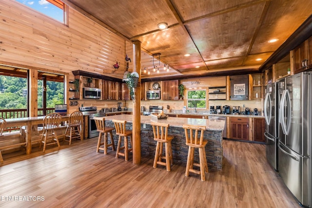 dining room featuring wood ceiling, wooden walls, and wood-type flooring