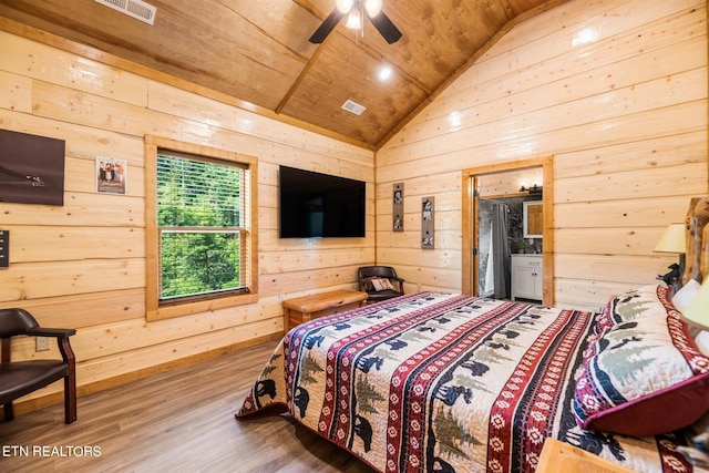 bedroom featuring wood walls, wood ceiling, vaulted ceiling, and hardwood / wood-style floors