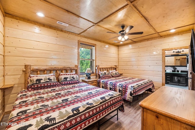 bedroom with wooden walls, ceiling fan, wood ceiling, and wood-type flooring