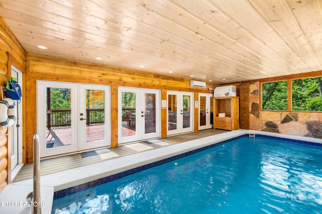 view of pool featuring french doors and a wall mounted air conditioner