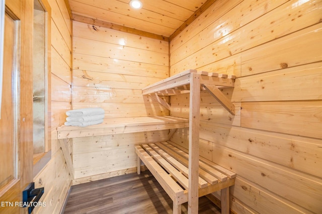 view of sauna with wooden walls, hardwood / wood-style floors, and wooden ceiling