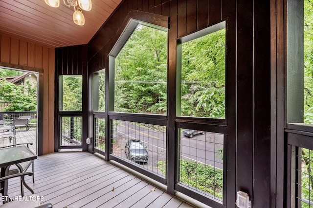 unfurnished sunroom featuring a healthy amount of sunlight and wooden ceiling