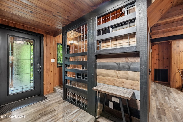 interior space with wooden ceiling, wood walls, and wood-type flooring