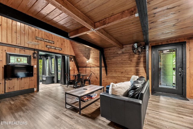 living room with beamed ceiling, wood walls, wood ceiling, and wood-type flooring