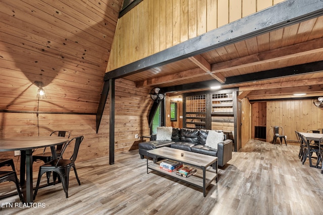 living room featuring wooden ceiling, wooden walls, and light wood-type flooring