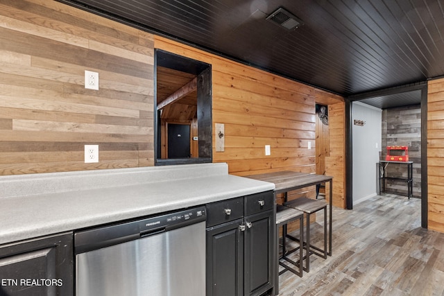 kitchen featuring dishwasher, wooden ceiling, wooden walls, and light hardwood / wood-style flooring