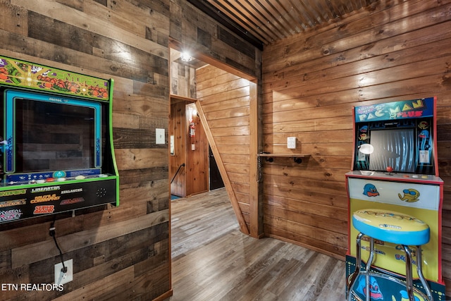 interior space with wood-type flooring and wood walls