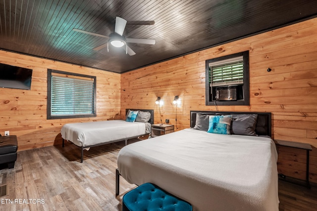 bedroom featuring wooden ceiling, wooden walls, and hardwood / wood-style floors