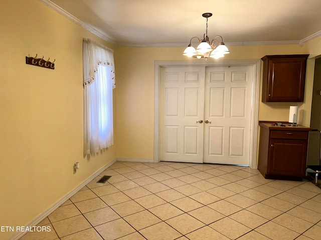 unfurnished dining area with a notable chandelier, ornamental molding, and light tile patterned floors