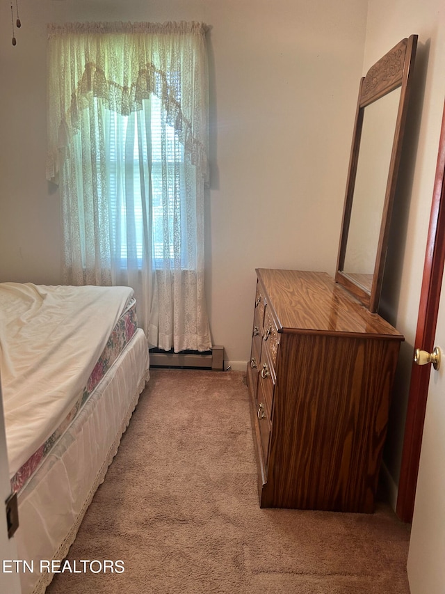 bedroom featuring light carpet and a baseboard radiator