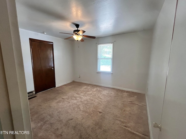 carpeted empty room featuring ceiling fan