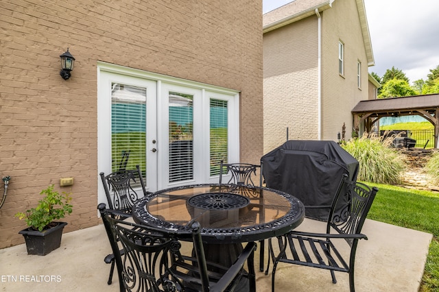 view of patio with a grill, a gazebo, and french doors