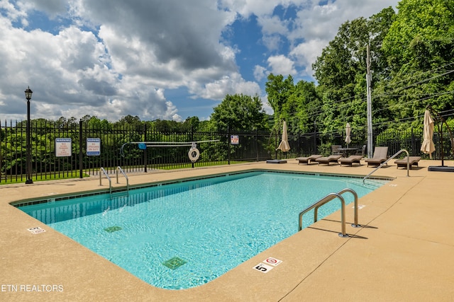 view of swimming pool with a patio