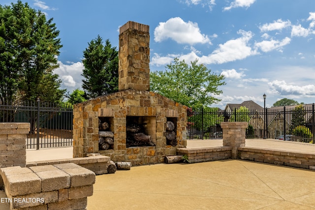 view of patio / terrace featuring an outdoor stone fireplace