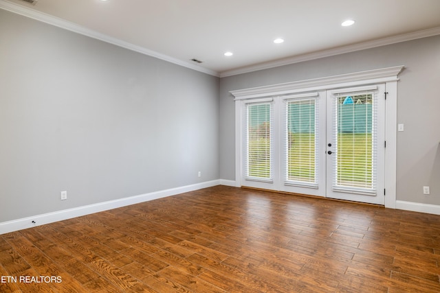 unfurnished room featuring french doors, ornamental molding, and hardwood / wood-style floors