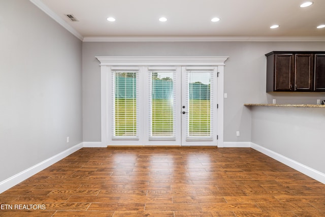 interior space featuring french doors, ornamental molding, and dark hardwood / wood-style floors