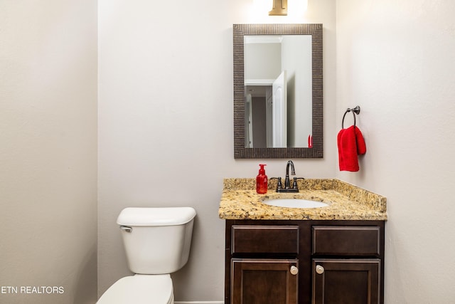 bathroom featuring toilet and vanity