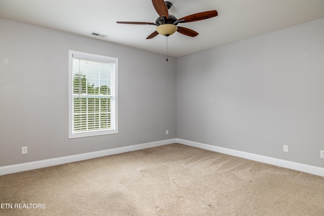 carpeted empty room featuring ceiling fan